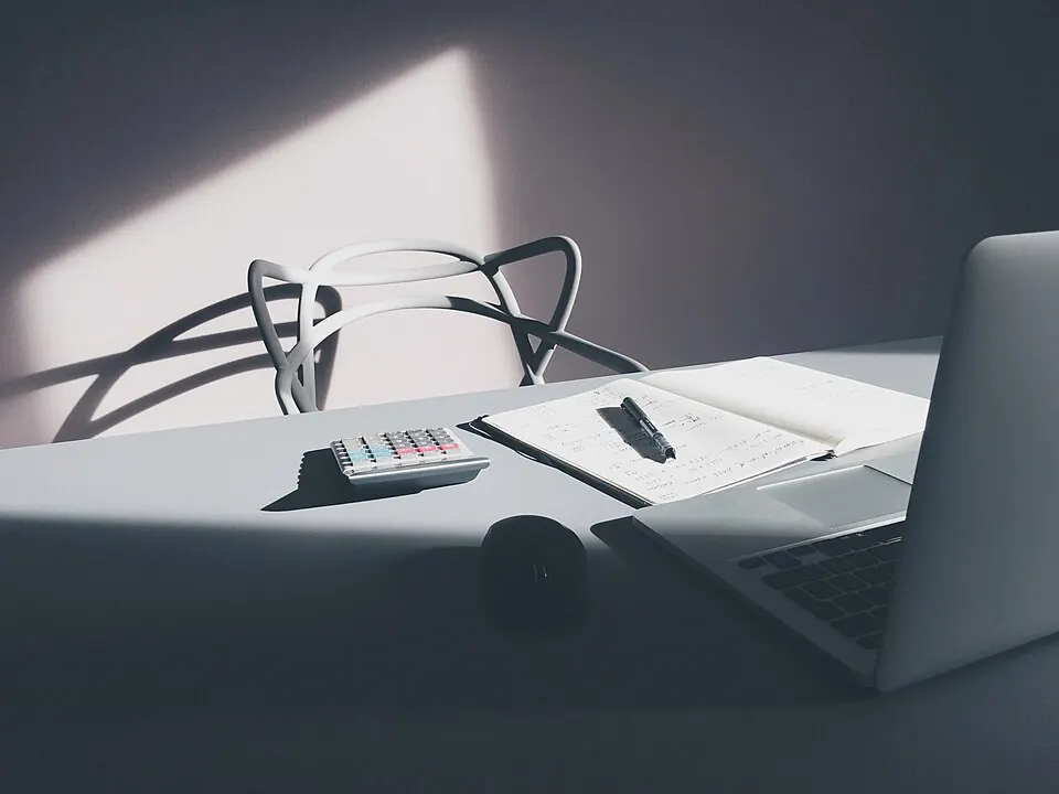 Laptop and calculator on a clean desk workspace