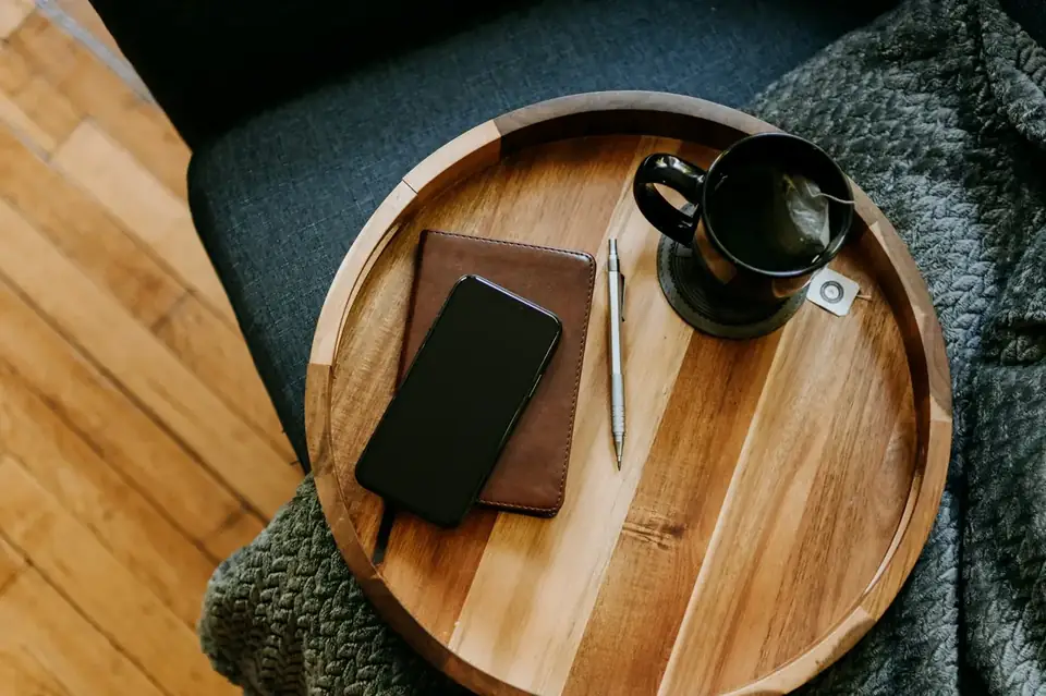 Desk with notebook, coffee, and phone