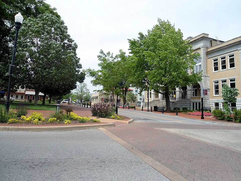 Downtown Bentonville streetscape with storefronts and parked cars