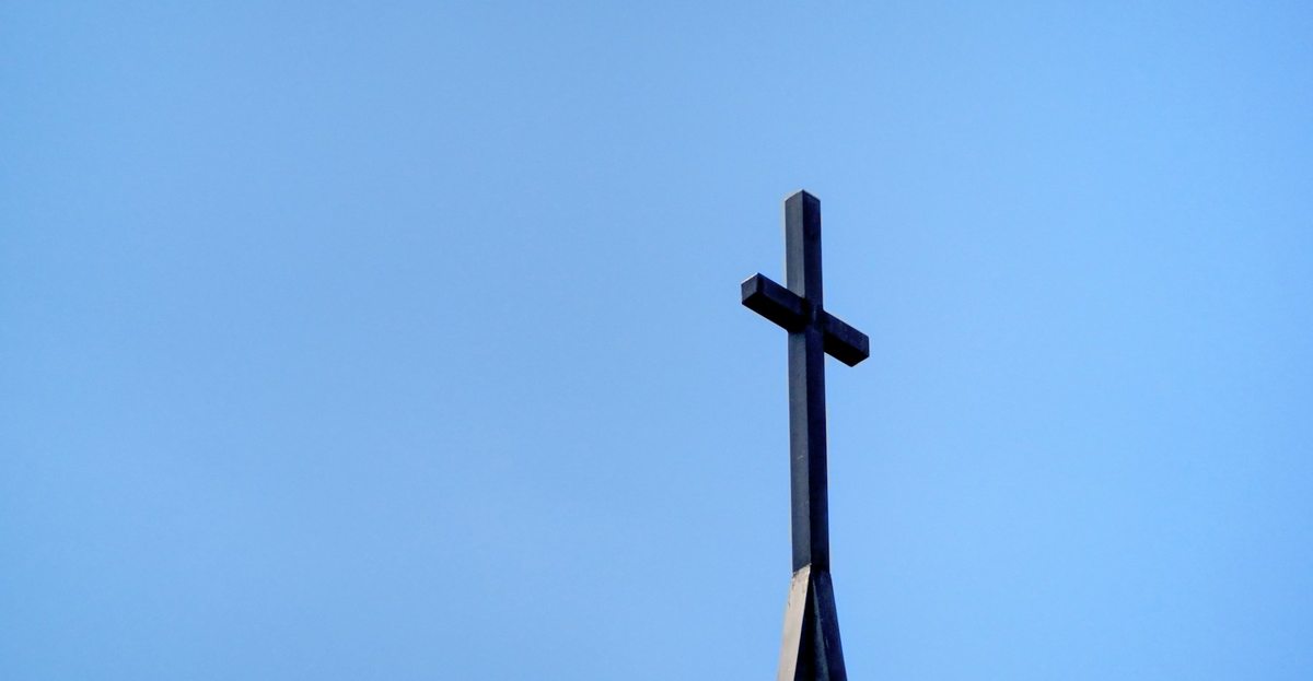 A simple cross against an open blue sky