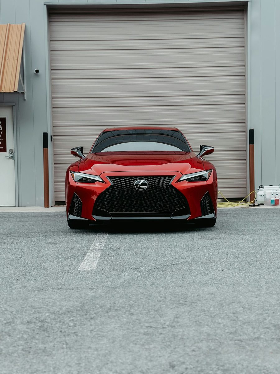 A polished red sports car outside a garage in Atlanta