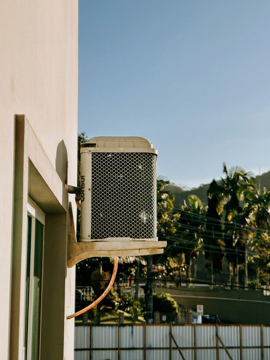 Outdoor air-conditioning equipment mounted beside a home