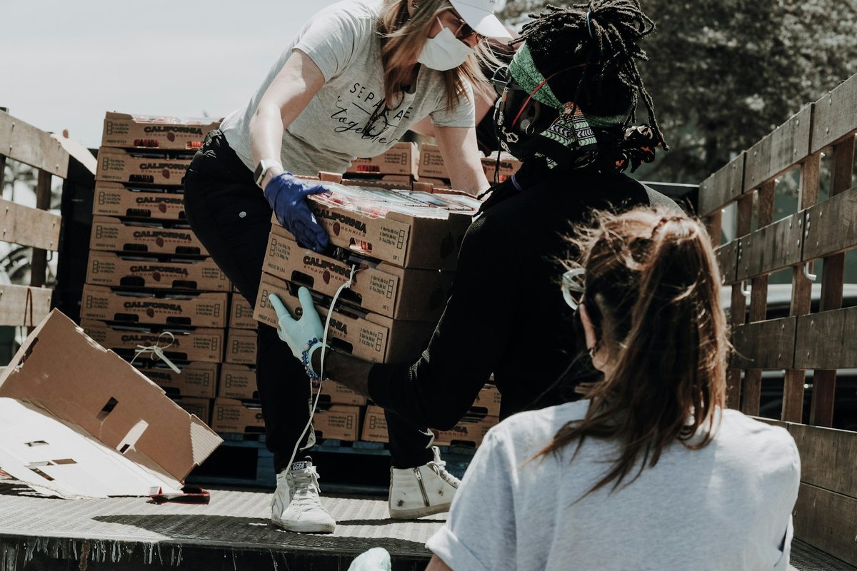 Volunteers working together to move boxes of supplies